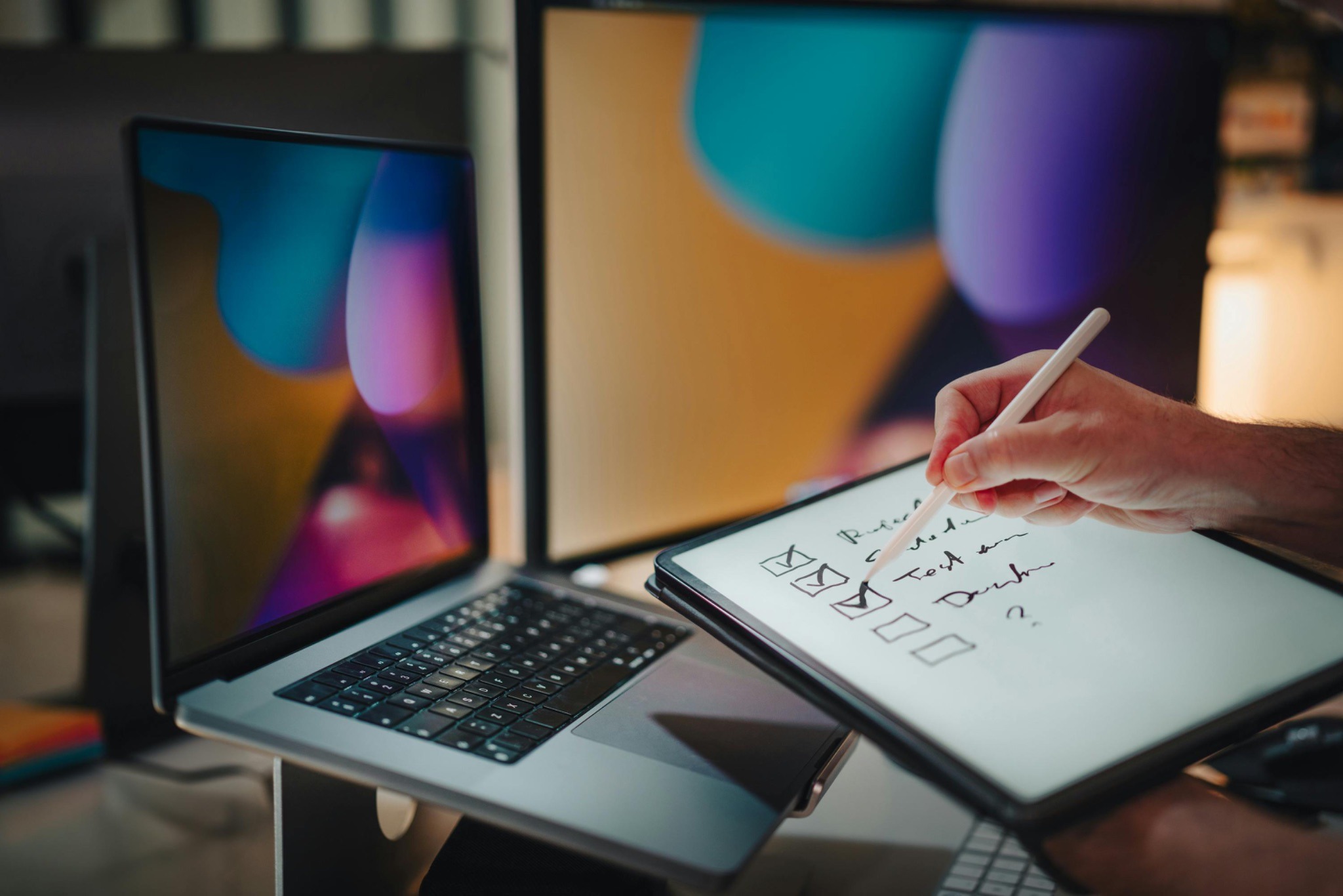 notes being written on paper from a laptop 