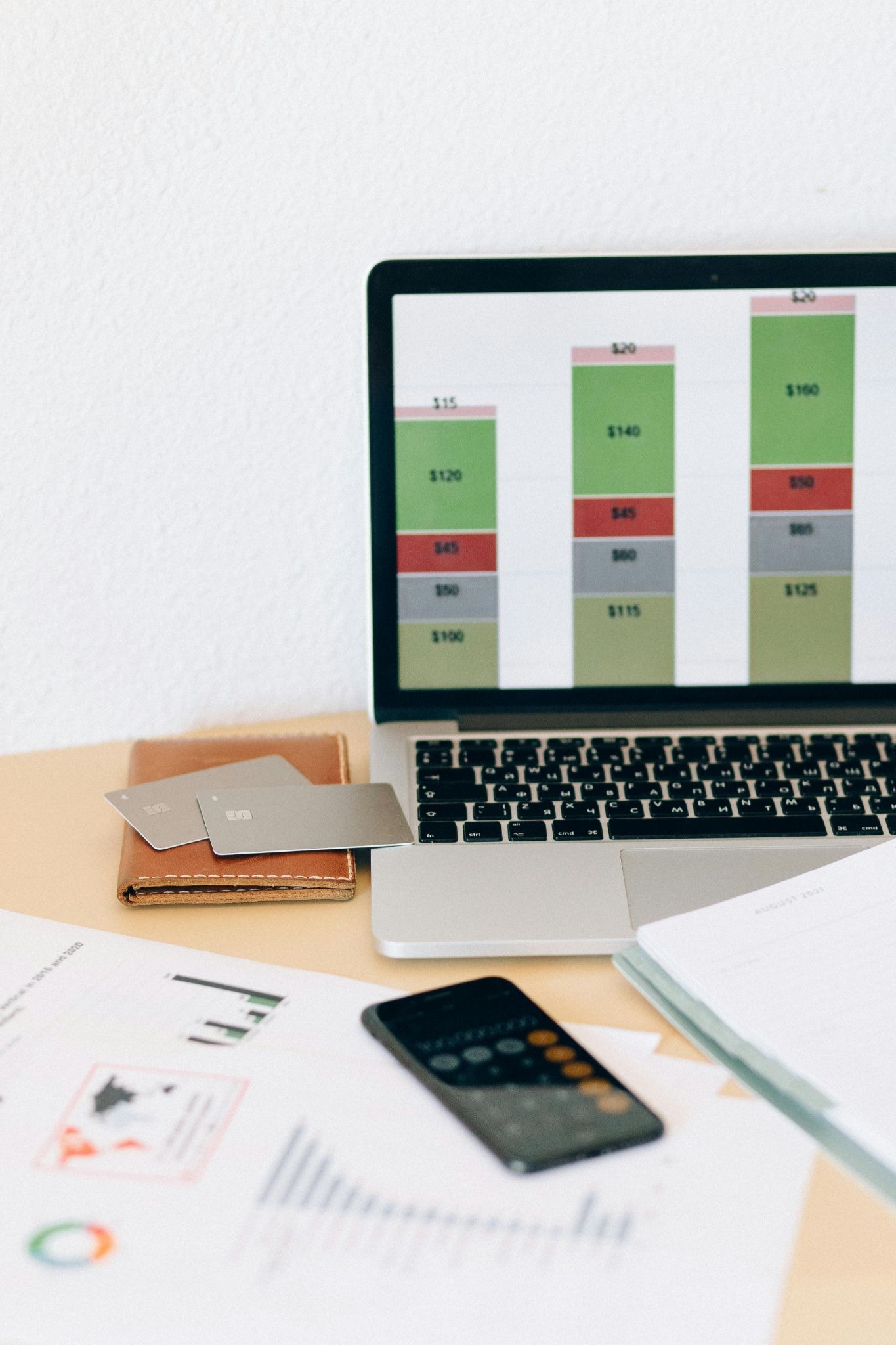 Data on a computer screen with paperwork around it 