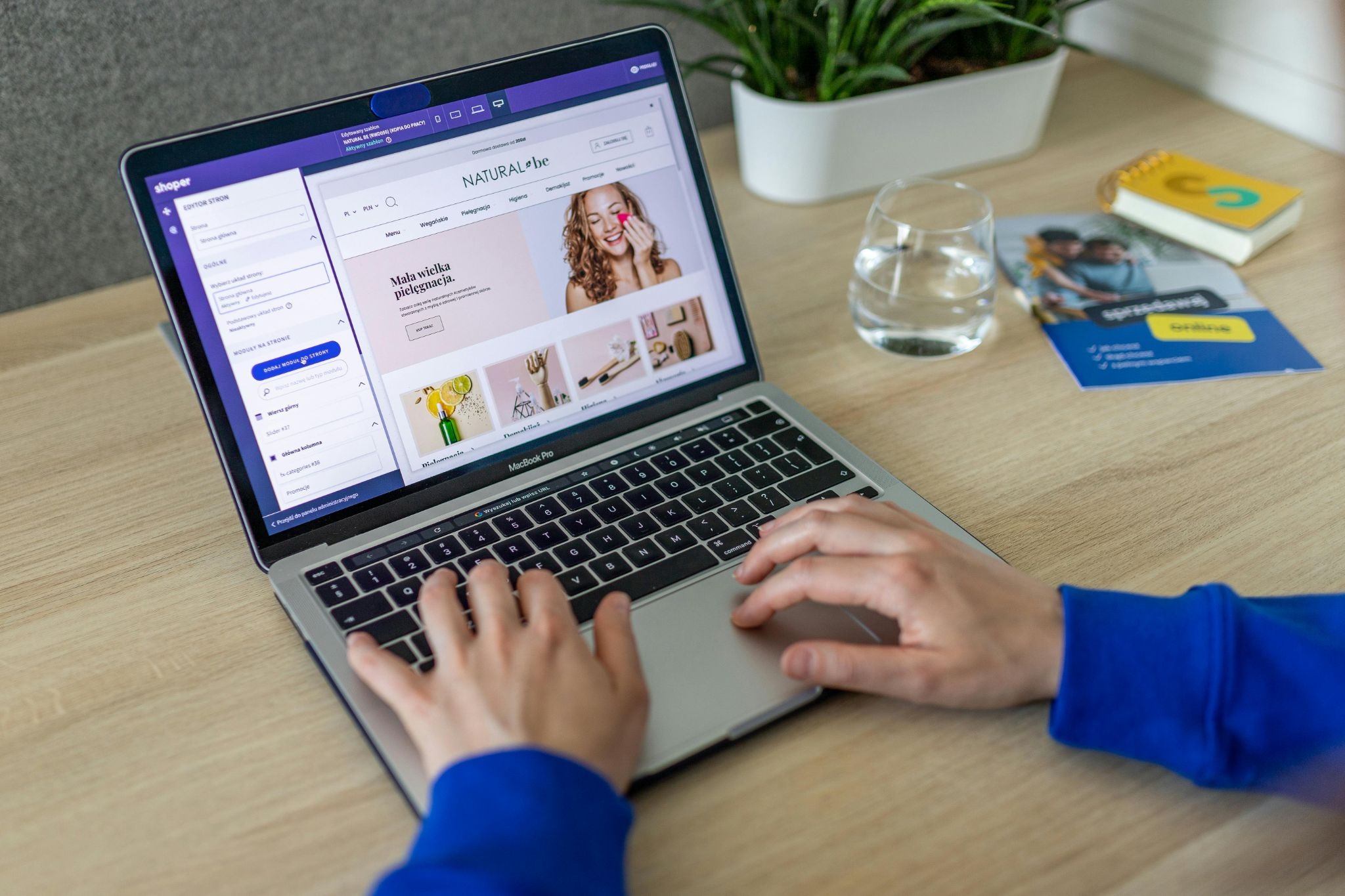 Picture of a person editing a natural beauty product storefront on a laptop computer