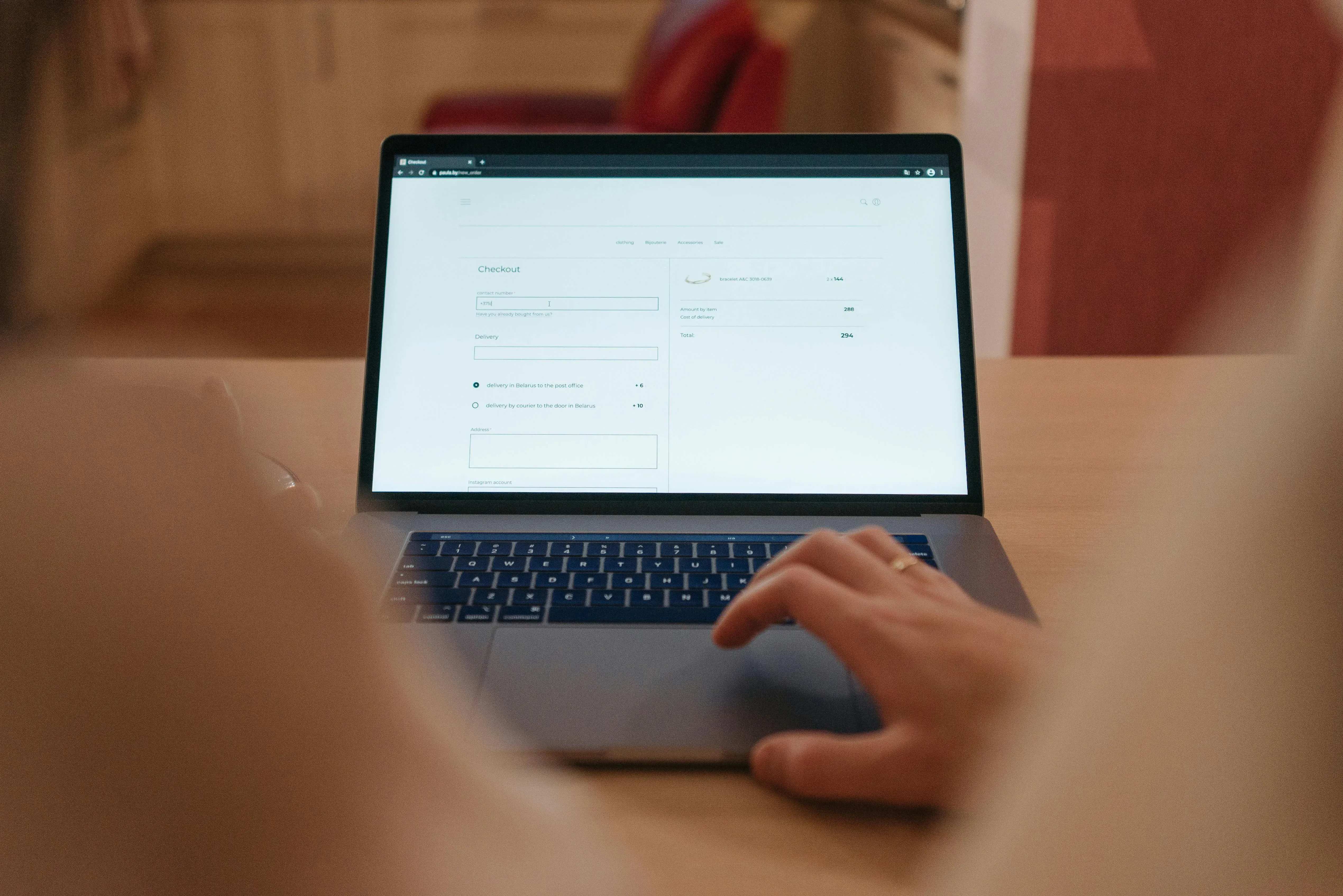 picture of a person browsing a clothing website on a laptop screen