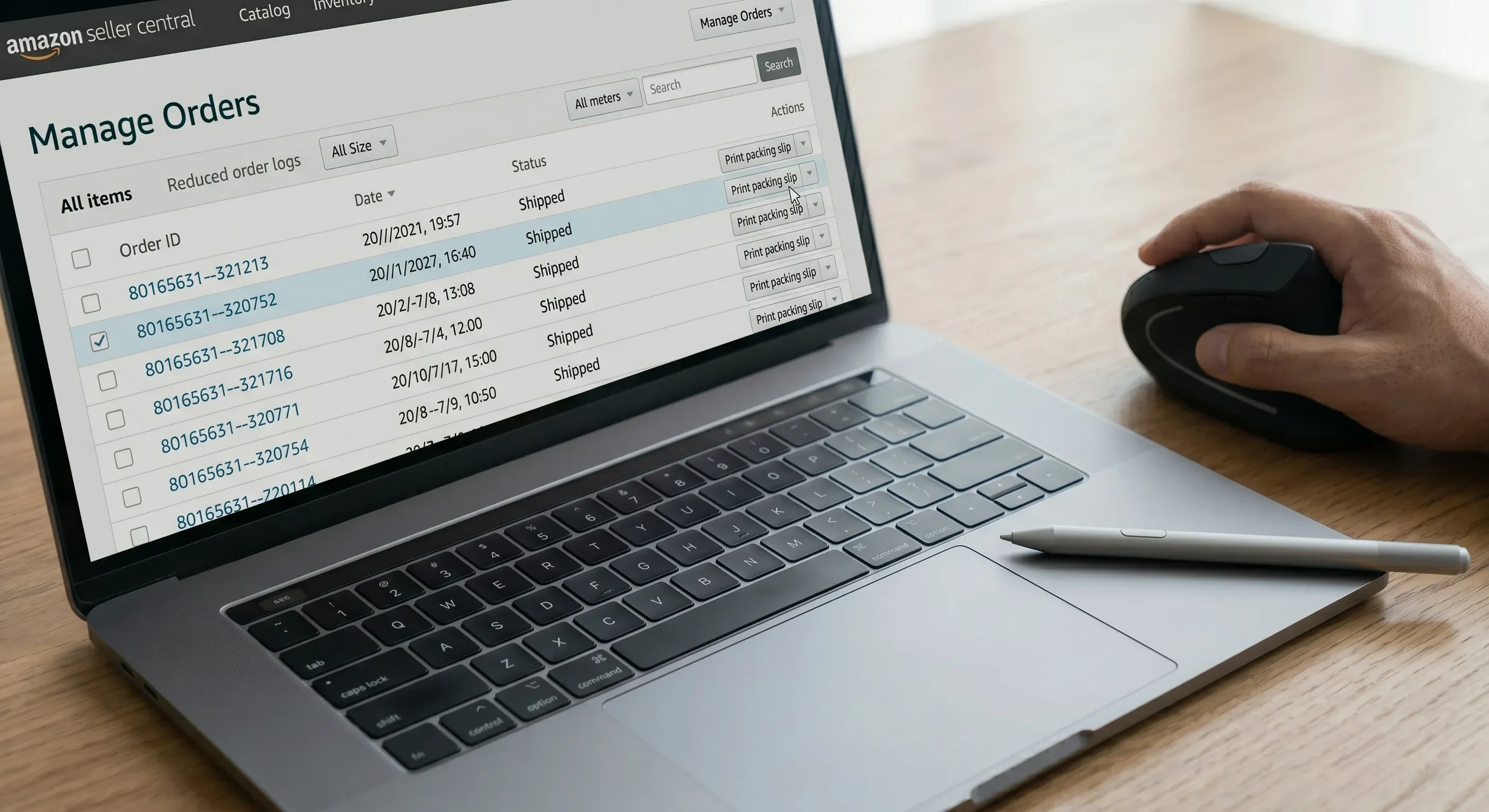 Picture of a person using a wireless mouse next to a laptop showing the Amazon Seller Central manage orders page